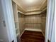 Spacious walk-in closet with built-in shelving and hardwood floors at 1308 Oakridge Ave # 3, Henderson, NC 27536