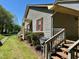 The home's exterior features wood siding, red shutters, a well-manicured lawn, and wooden stairs leading to the entrance at 1308 Oakridge Ave # 3, Henderson, NC 27536