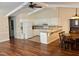 Bright, open kitchen with white cabinets, adjacent dining area, and hardwood floors at 1308 Oakridge Ave # 3, Henderson, NC 27536