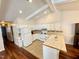 Bright kitchen with white cabinets, a breakfast bar, and tile backsplash at 1308 Oakridge Ave # 3, Henderson, NC 27536