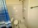 Accessible shower with seating and blue shower curtain at 1308 Oakridge Ave # 3, Henderson, NC 27536