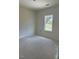 Unfinished bedroom with a window offering neighborhood views at 136 Baneberry Pl, Broadway, NC 27505