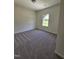 Cozy bedroom featuring plush carpeting and natural light from the window at 136 Baneberry Pl, Broadway, NC 27505