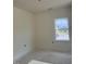 Unfinished bedroom with a bright window offering neighborhood views at 136 Baneberry Pl, Broadway, NC 27505