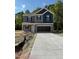 Charming two-story home featuring a gray and navy blue color scheme with a spacious two car garage at 136 Baneberry Pl, Broadway, NC 27505