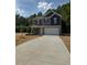 Charming two-story home featuring a gray and navy blue color scheme with a spacious two car garage at 136 Baneberry Pl, Broadway, NC 27505