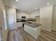 Well-lit kitchen with white cabinets, stainless appliances, and granite-topped island at 136 Baneberry Pl, Broadway, NC 27505