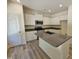 Bright kitchen features white cabinets, stainless steel appliances, and a granite-topped island at 136 Baneberry Pl, Broadway, NC 27505