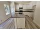 Well-lit kitchen boasts a granite-topped island, ample cabinet space, and stainless steel appliances at 136 Baneberry Pl, Broadway, NC 27505