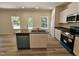 Open kitchen showcases a central island, white cabinets, and stainless steel appliances at 136 Baneberry Pl, Broadway, NC 27505