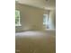 Spacious living room with bright, natural light coming in from two windows at 136 Baneberry Pl, Broadway, NC 27505