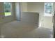 A bright loft area featuring two large windows, creating a versatile and inviting space at 136 Baneberry Pl, Broadway, NC 27505