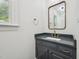 Updated powder room features a modern vanity with stylish mirror, new hardware, and marble countertop at 14 W Bridlewood Trl, Durham, NC 27713