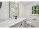 Bathroom with white marble countertops, a large mirror, and natural light at 14 W Bridlewood Trl, Durham, NC 27713