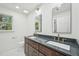 Modern bathroom features dual sinks with dark wood cabinetry and a large mirror at 14 W Bridlewood Trl, Durham, NC 27713