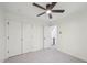 Bedroom featuring a ceiling fan, neutral carpet, and a double door closet at 14 W Bridlewood Trl, Durham, NC 27713