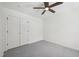 Bright bedroom features a ceiling fan, closet with doors, and neutral carpeting at 14 W Bridlewood Trl, Durham, NC 27713
