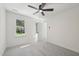 Bedroom featuring a ceiling fan, neutral carpet, and a large window with a view to the front yard at 14 W Bridlewood Trl, Durham, NC 27713