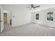 Bright bedroom featuring carpeting, a ceiling fan, and two windows for natural light at 14 W Bridlewood Trl, Durham, NC 27713