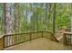 Wooden deck overlooking a lush, mature forest at 14 W Bridlewood Trl, Durham, NC 27713