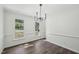 Dining room boasts modern lighting, chair railing, and view to the front yard at 14 W Bridlewood Trl, Durham, NC 27713