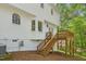 A bright exterior showing a deck and stairs ascending to the white siding of this beautiful home at 14 W Bridlewood Trl, Durham, NC 27713