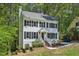 Charming two-story home featuring a white exterior with black shutters, surrounded by mature trees at 14 W Bridlewood Trl, Durham, NC 27713