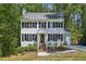 Charming two-story home featuring black shutters, a brick-lined stairway, and a well-maintained front yard at 14 W Bridlewood Trl, Durham, NC 27713