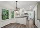 Bright kitchen features stainless steel appliances, white cabinetry, and eat-in breakfast nook with large windows at 14 W Bridlewood Trl, Durham, NC 27713