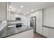 Kitchen features stainless appliances, quartz countertops and ample cabinet space at 14 W Bridlewood Trl, Durham, NC 27713