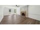 Bright living room features a cozy fireplace, hardwood floors, and white trim at 14 W Bridlewood Trl, Durham, NC 27713