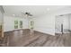 Spacious living room featuring new vinyl floors, neutral paint and french doors at 14 W Bridlewood Trl, Durham, NC 27713