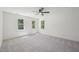 Bright main bedroom with large windows, ceiling fan, and carpeted floor at 14 W Bridlewood Trl, Durham, NC 27713