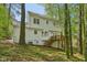 Charming two-story home with a wooden deck surrounded by lush trees at 14 W Bridlewood Trl, Durham, NC 27713
