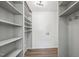 A walk-in closet with built-in shelving and wood-look flooring at 14 W Bridlewood Trl, Durham, NC 27713