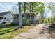 Backyard showing large porch of waterfront home with an expansive treed yard at 150 Big Horn Cv, Louisburg, NC 27549