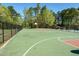 Community basketball court surrounded by a black chain link fence and lush trees at 150 Big Horn Cv, Louisburg, NC 27549