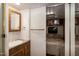Bathroom with single sink vanity and mirror, leading to a bedroom with comfortable furnishings and soft lighting at 150 Big Horn Cv, Louisburg, NC 27549