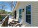 The back side of a yellow home with a wooden porch overlooking the lake at 150 Big Horn Cv, Louisburg, NC 27549