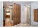 Hallway and bath feature wood flooring and convenient linen closet at 150 Big Horn Cv, Louisburg, NC 27549
