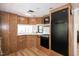 Efficient kitchen with wooden cabinets, modern appliances, and ample natural light, ready for culinary adventures at 150 Big Horn Cv, Louisburg, NC 27549