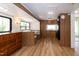 Open living area features wood-style flooring, built-in dining booth, and plentiful storage at 150 Big Horn Cv, Louisburg, NC 27549