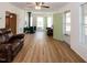 Spacious living room with hardwood floors, leather furniture, and cozy fireplace, perfect for relaxation at 150 Big Horn Cv, Louisburg, NC 27549