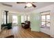 Open-concept living area boasting wood floors, many windows, and dual entry doors at 150 Big Horn Cv, Louisburg, NC 27549