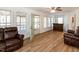 Bright living room with hardwood floors and leather furniture at 150 Big Horn Cv, Louisburg, NC 27549