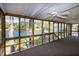The porch features multiple ceiling fans and a view of the lake at 150 Big Horn Cv, Louisburg, NC 27549