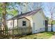 Side view of a lakeside house with a fenced yard at 150 Big Horn Cv, Louisburg, NC 27549