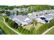 Expansive aerial view showcases the beautiful neighborhood with lush trees, pond, and well-maintained homes at 150 Red Admiral Ct, Hillsborough, NC 27278