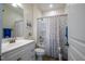 Bright bathroom featuring a white vanity, shower with patterned curtain, and neutral tones at 150 Red Admiral Ct, Hillsborough, NC 27278