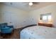 Bedroom features a decorative quilt, wood floors, and a blue accent chair at 150 Red Admiral Ct, Hillsborough, NC 27278